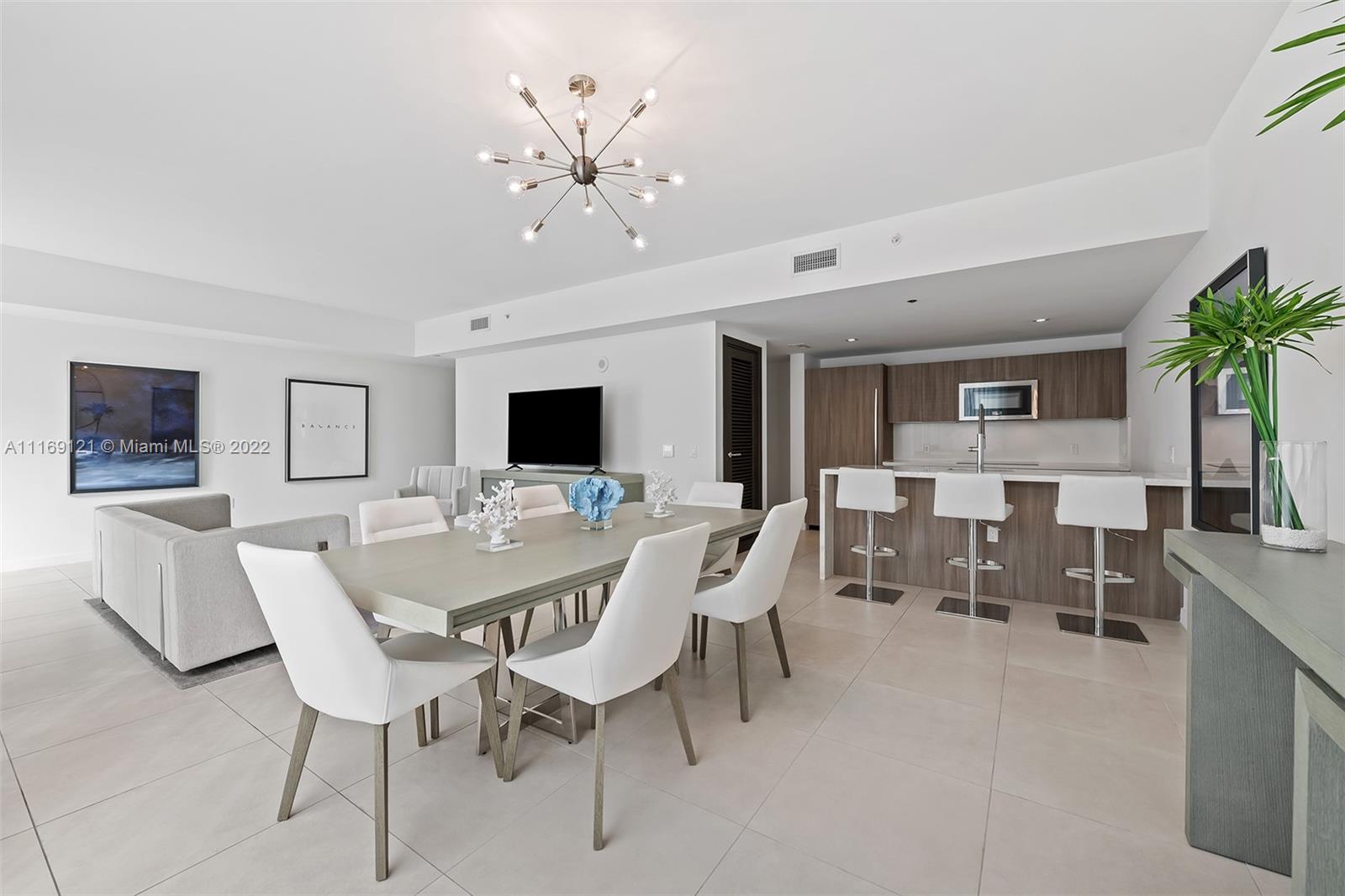 401 North Birch Road, Unit TH7 Fort Lauderdale, FL 33304 - Photo 5 of 29 a view of a dining room with furniture and wooden floor