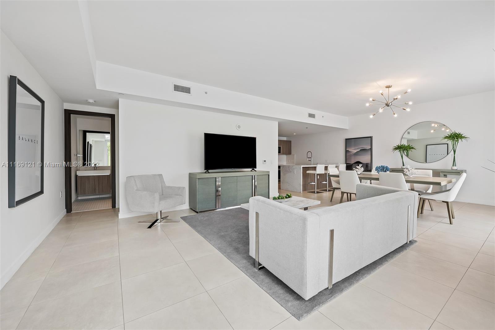 401 North Birch Road, Unit TH7 Fort Lauderdale, FL 33304 - Photo 6 of 29 a living room with furniture and a flat screen tv