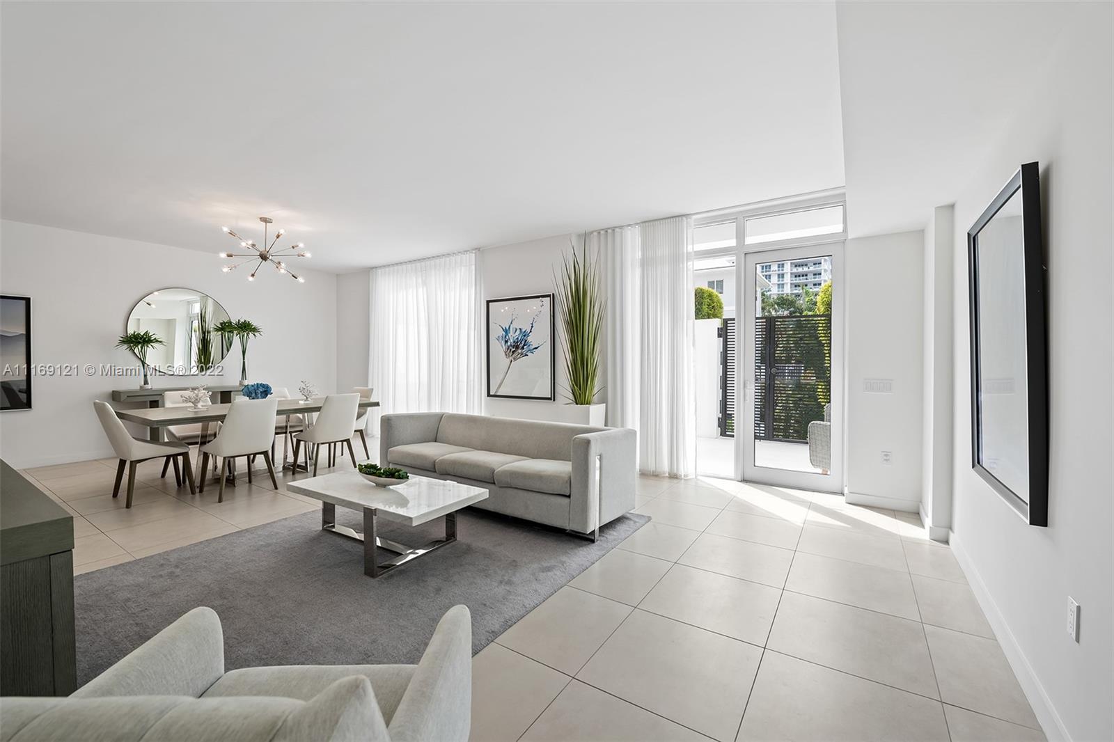 401 North Birch Road, Unit TH7 Fort Lauderdale, FL 33304 - Photo 7 of 29 a living room with furniture and a large window