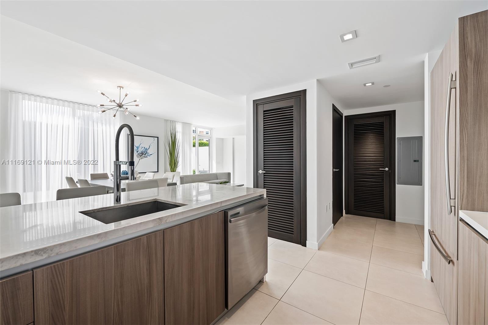 401 North Birch Road, Unit TH7 Fort Lauderdale, FL 33304 - Photo 10 of 29 a kitchen with a sink and a refrigerator