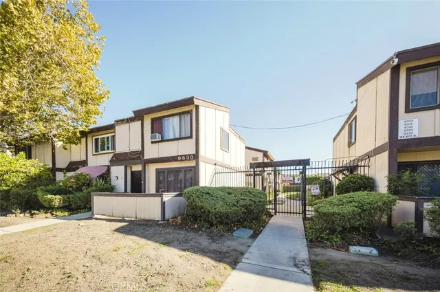 a view of a white house next to a road