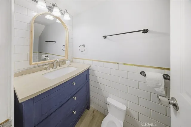 a bathroom with a sink mirror and toilet