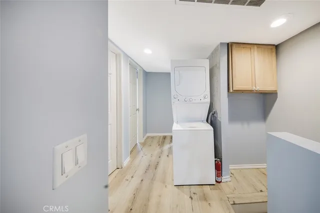 a hallway with furniture and wooden floor