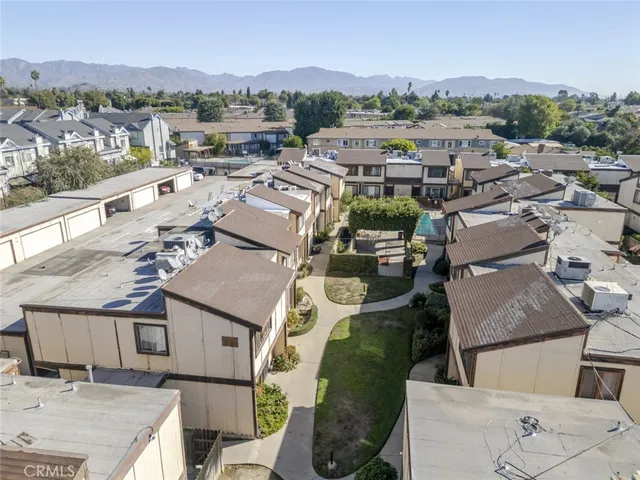 an aerial view of a house with a mountain