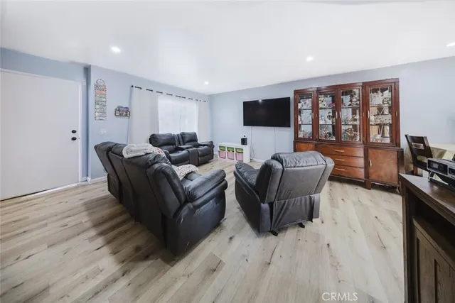 a living room with furniture window and a flat screen tv