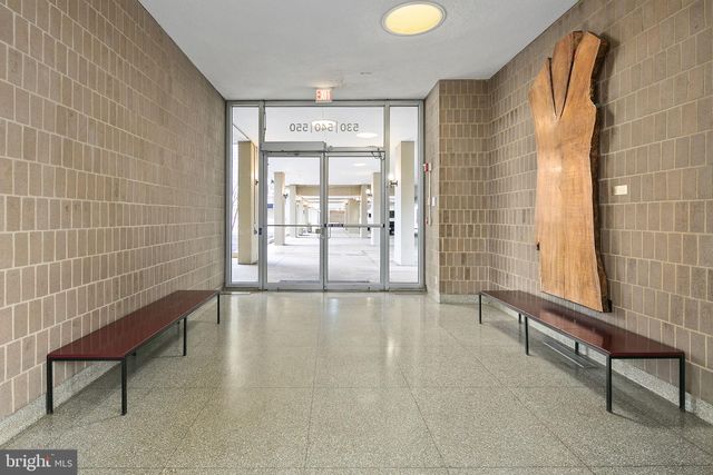 a view of an empty room with a birdcage and a window