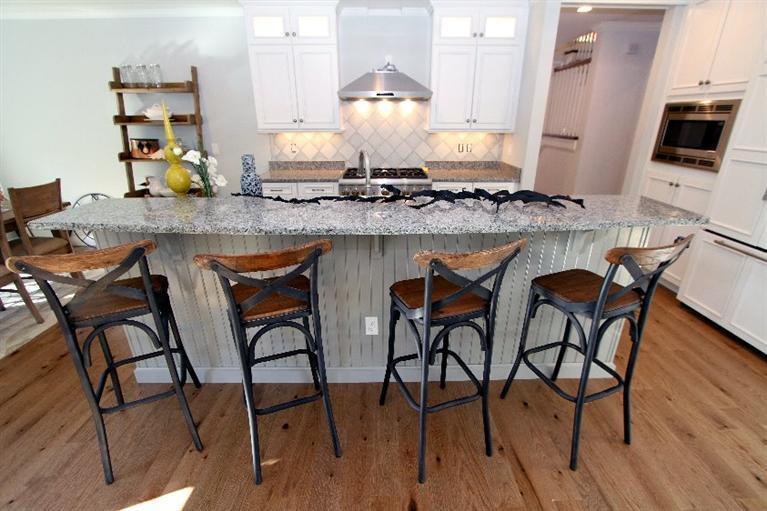 14 Cross Road Mashpee, MA 02649 - Photo 13 of 35 a kitchen with stainless steel appliances granite countertop table chairs and chandelier