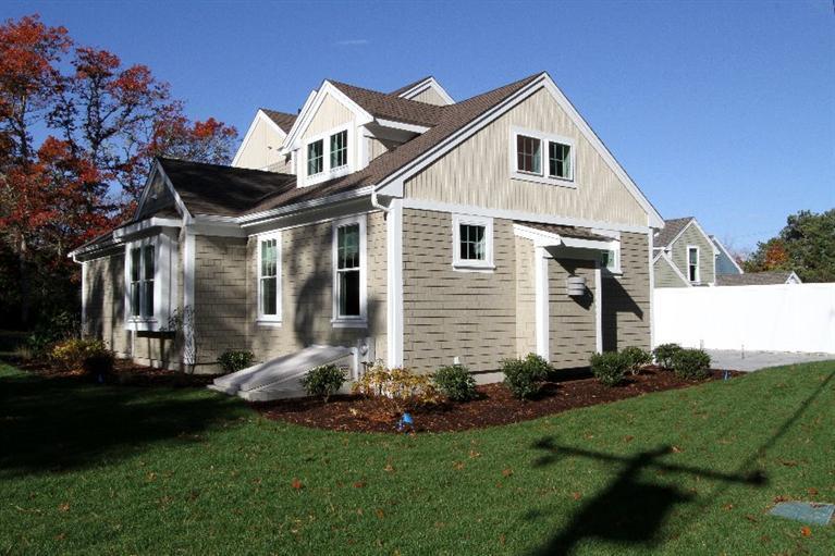 14 Cross Road Mashpee, MA 02649 - Photo 28 of 35 a front view of a house with a yard and trees