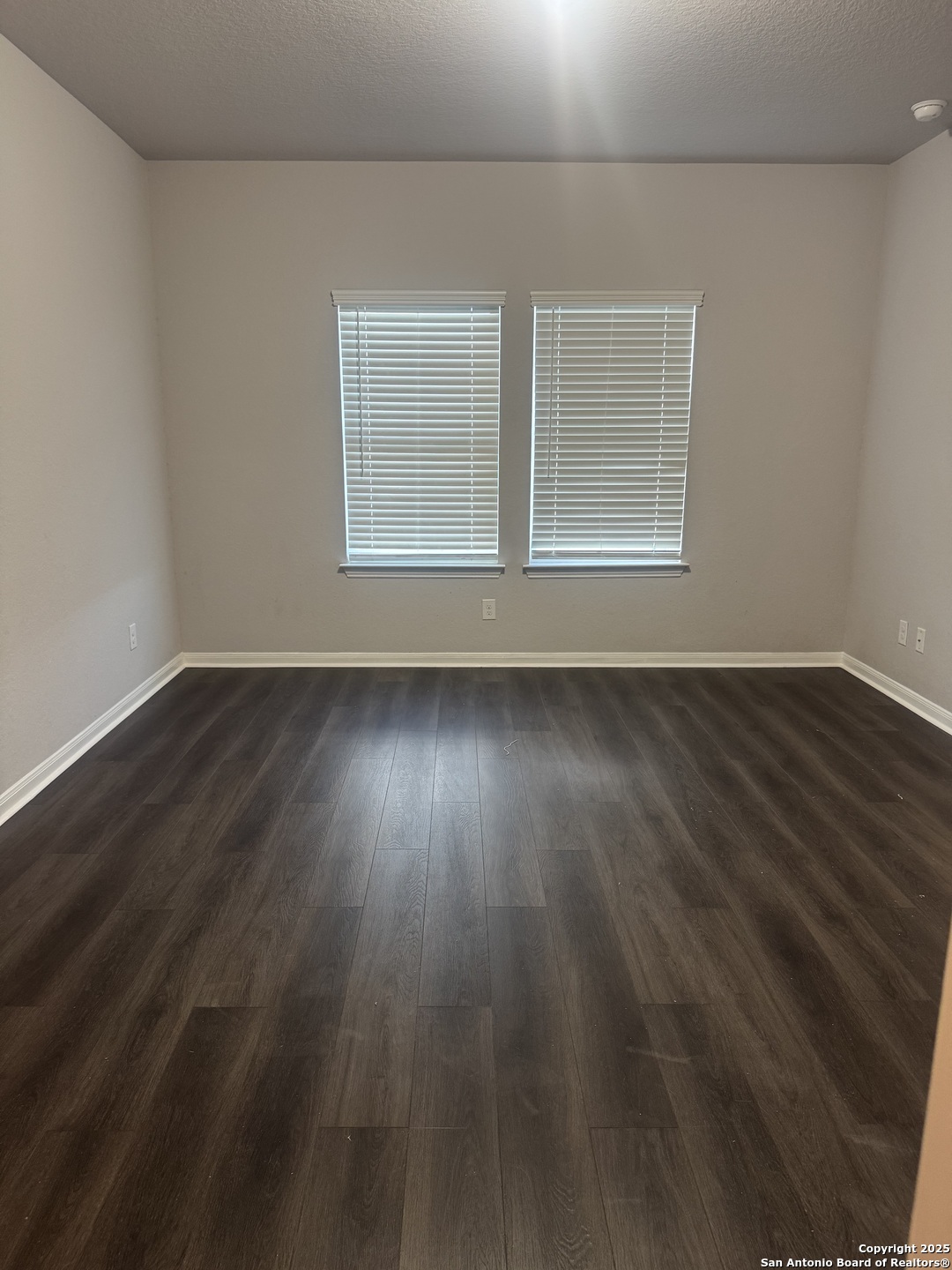 473 Hunters Ranch East San Antonio, TX 78253 - Photo 5 of 11 an empty room with wooden floor and windows