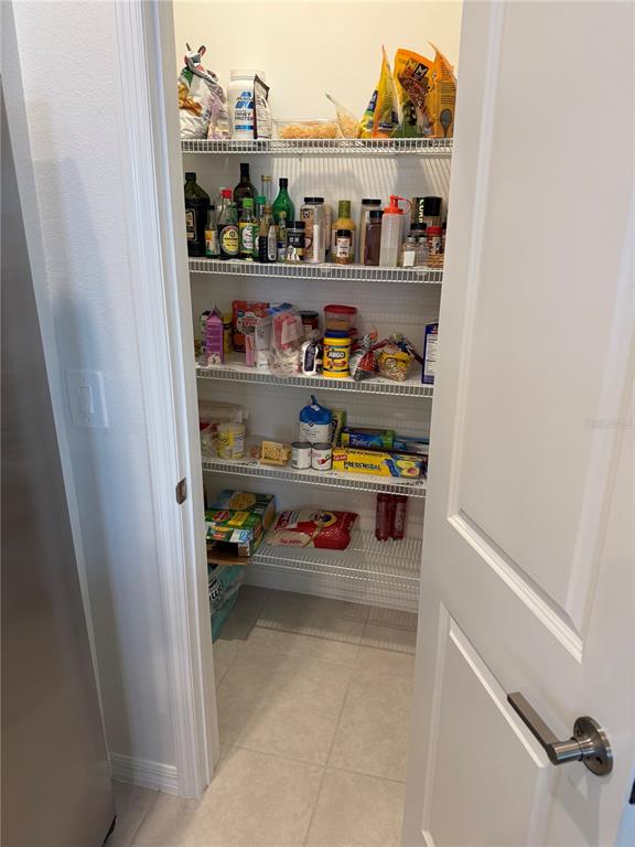 9276 Bonita Mar Drive Parrish, FL 34219 - Photo 17 of 54 a shelf with cup and plates