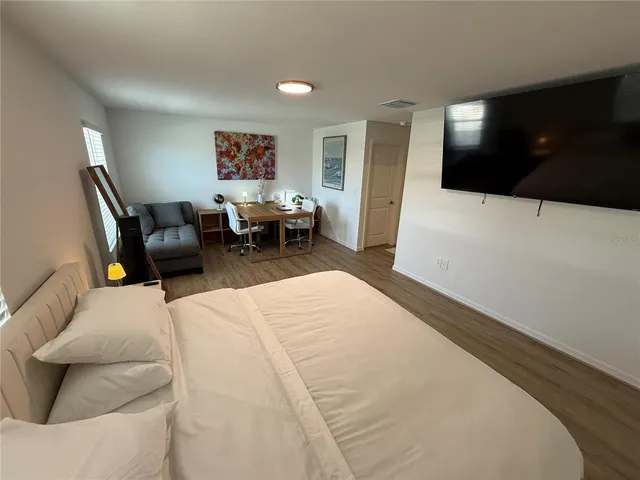 a bath tub sitting next to a white sink and vanity