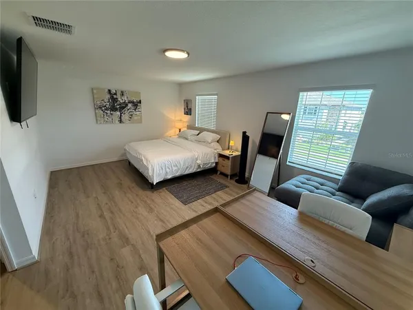 a spacious bathroom with a double vanity sink toilet and mirror
