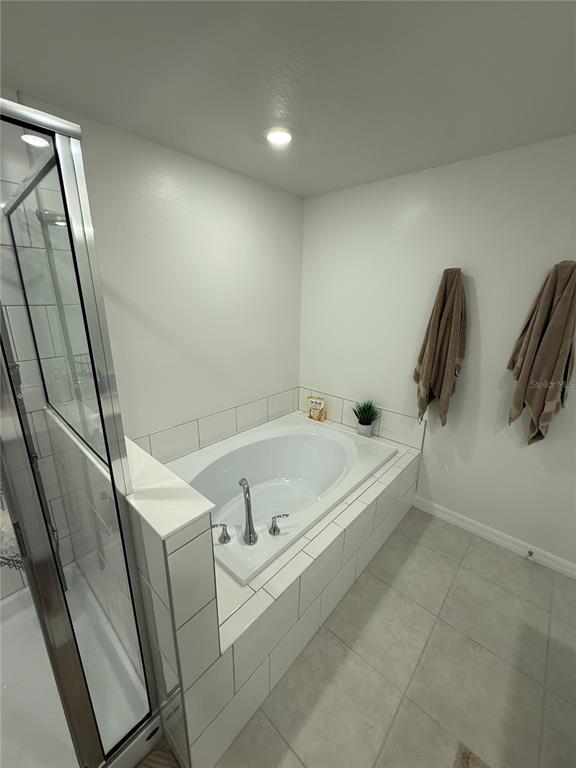 9276 Bonita Mar Drive Parrish, FL 34219 - Photo 33 of 54 a bath tub sitting next to a white sink and vanity