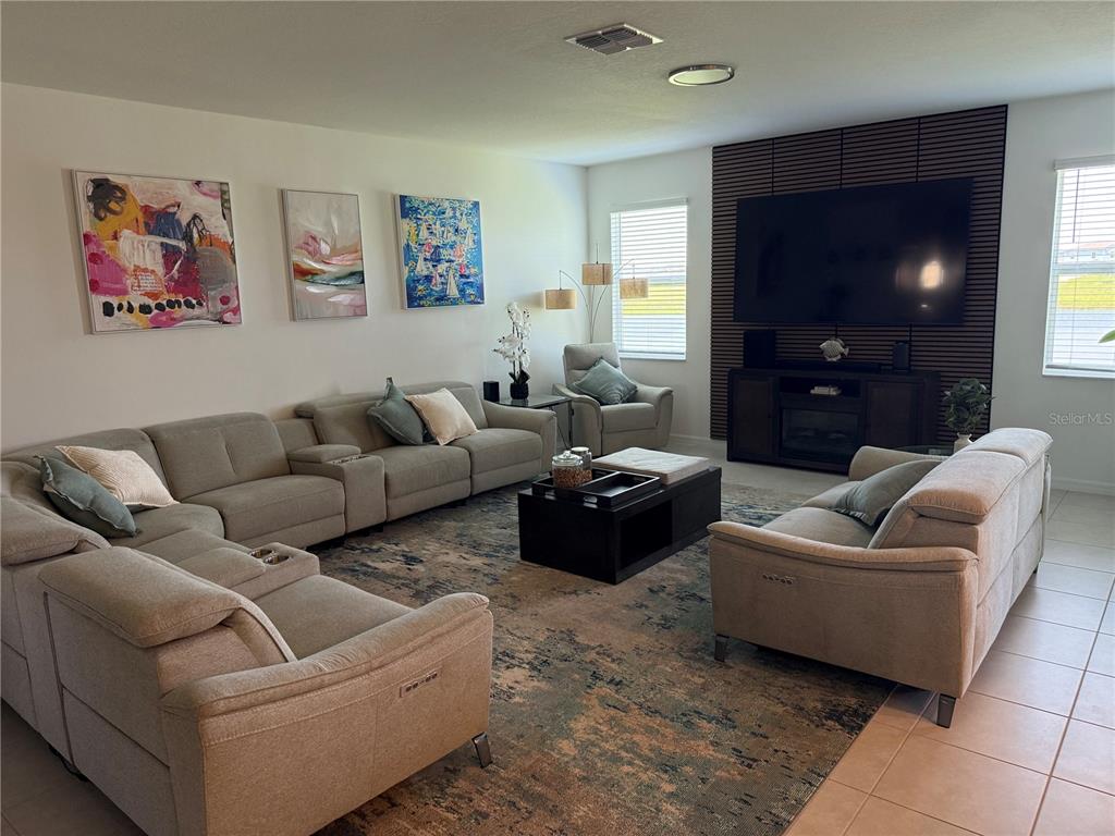 9276 Bonita Mar Drive Parrish, FL 34219 - Photo 41 of 54 a living room with furniture and a flat screen tv