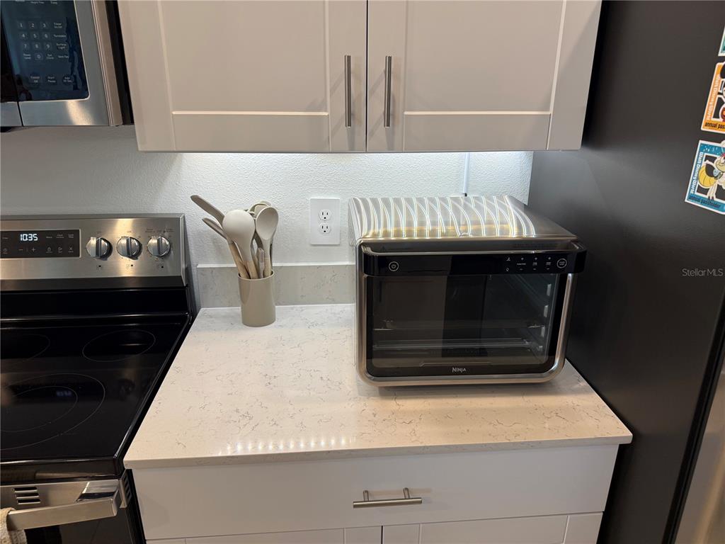 9276 Bonita Mar Drive Parrish, FL 34219 - Photo 52 of 54 a stove top oven sitting inside of a kitchen