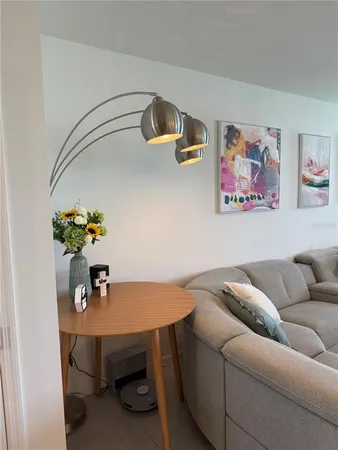 a living room with furniture and flower pot