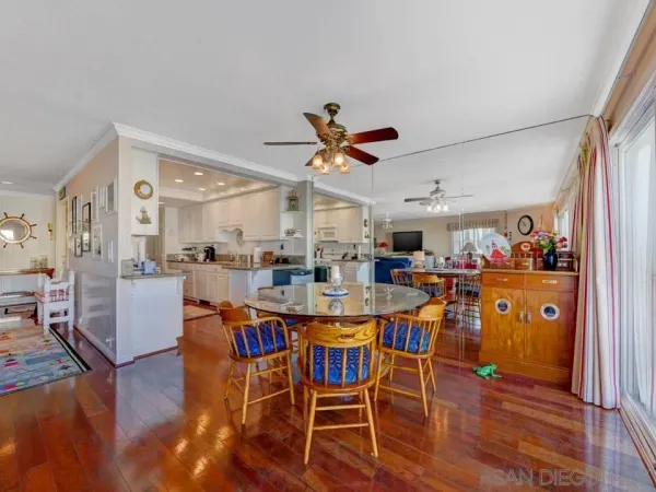 a view of a dining room with furniture and a chandelier