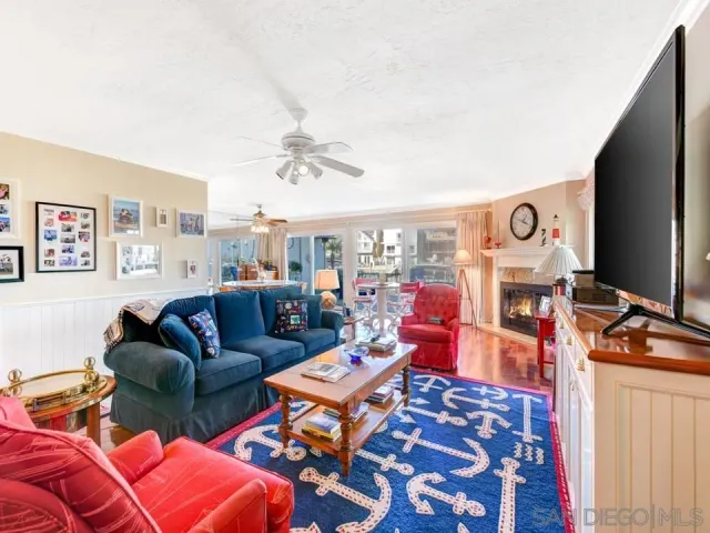 a living room with furniture a rug and a flat screen tv