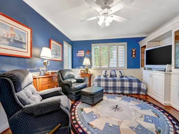 a bedroom with furniture and a flat screen tv