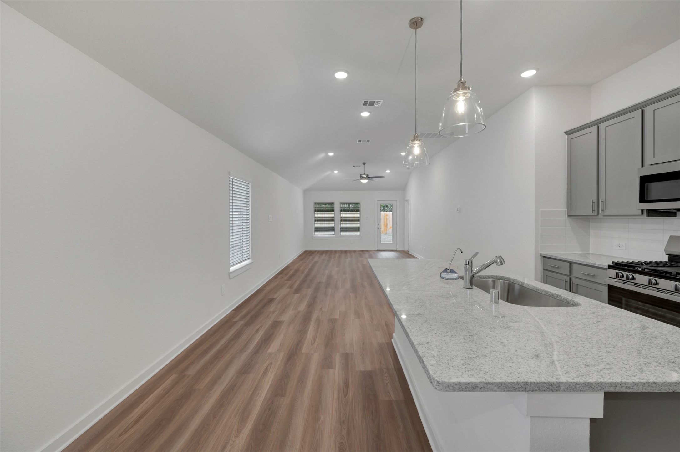 20534 Draper Road Tomball, TX 77377 - Photo 18 of 33 a room with kitchen island a sink and wooden floor