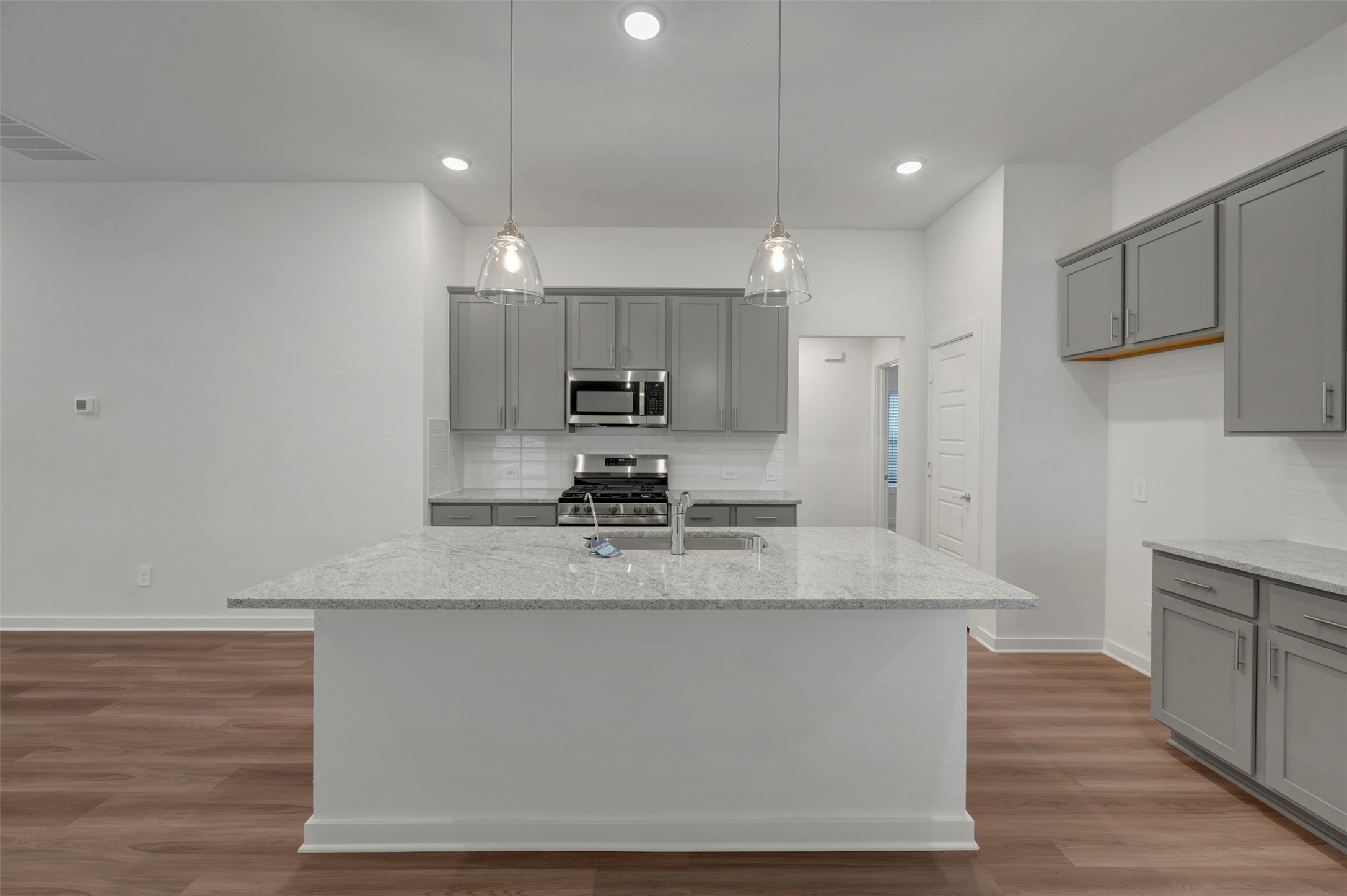 20534 Draper Road Tomball, TX 77377 - Photo 4 of 33 a large kitchen with stainless steel appliances a large counter top a stove a refrigerator and a sink