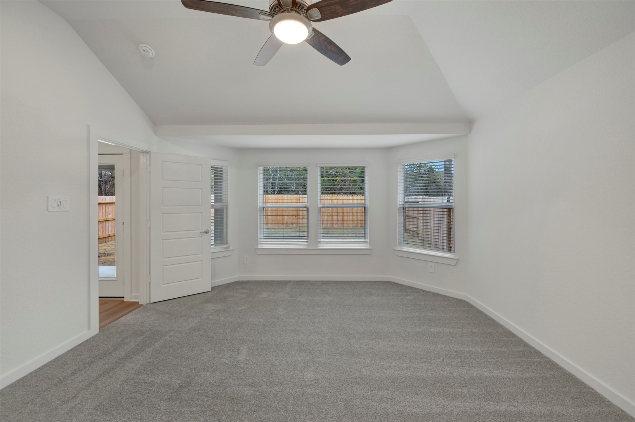 20534 Draper Road Tomball, TX 77377 - Photo 6 of 33 an empty room with windows and fan
