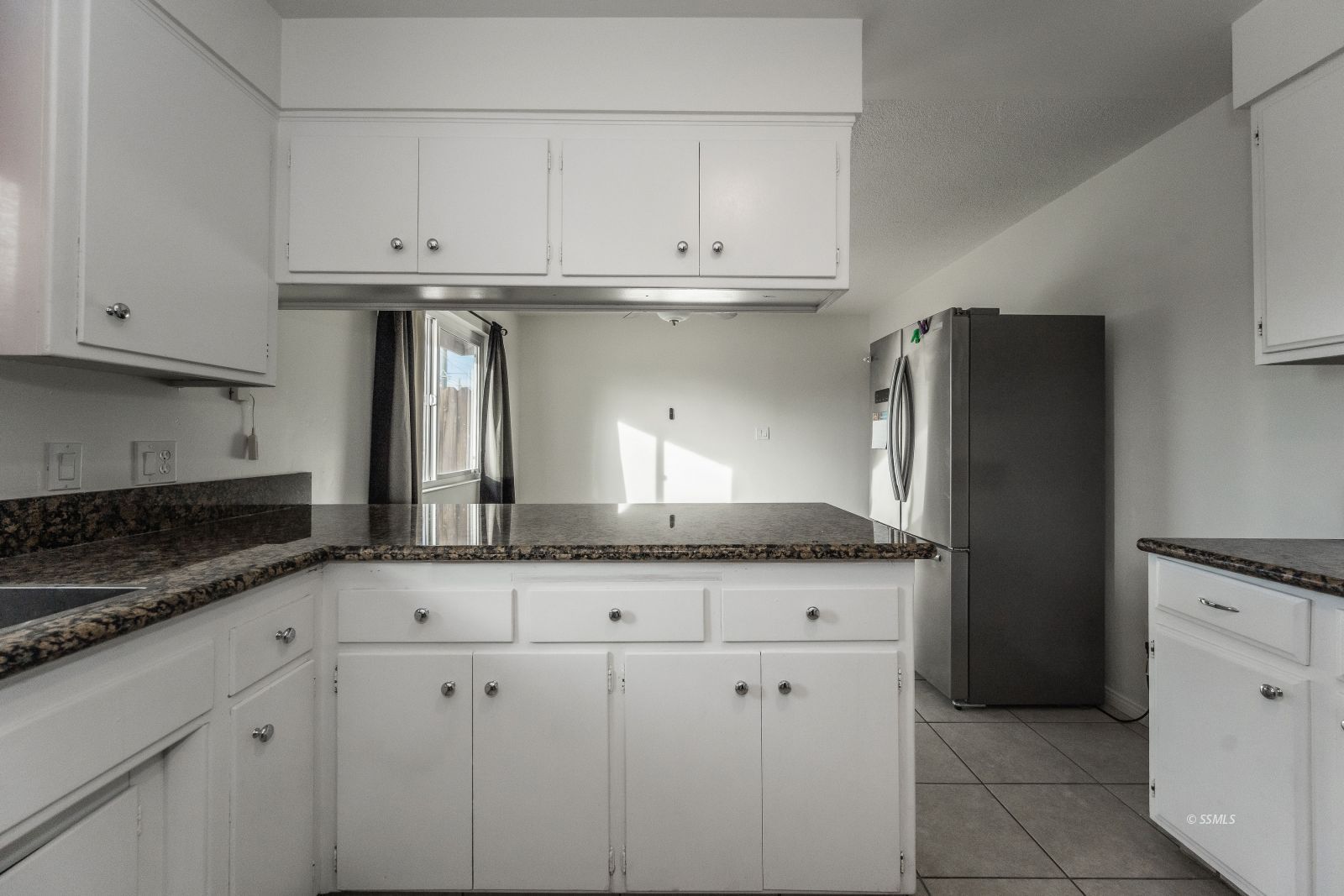 412 East Church Avenue Ridgecrest, CA 93555 - Photo 10 of 39 a kitchen with granite countertop white cabinets and a stainless steel appliances