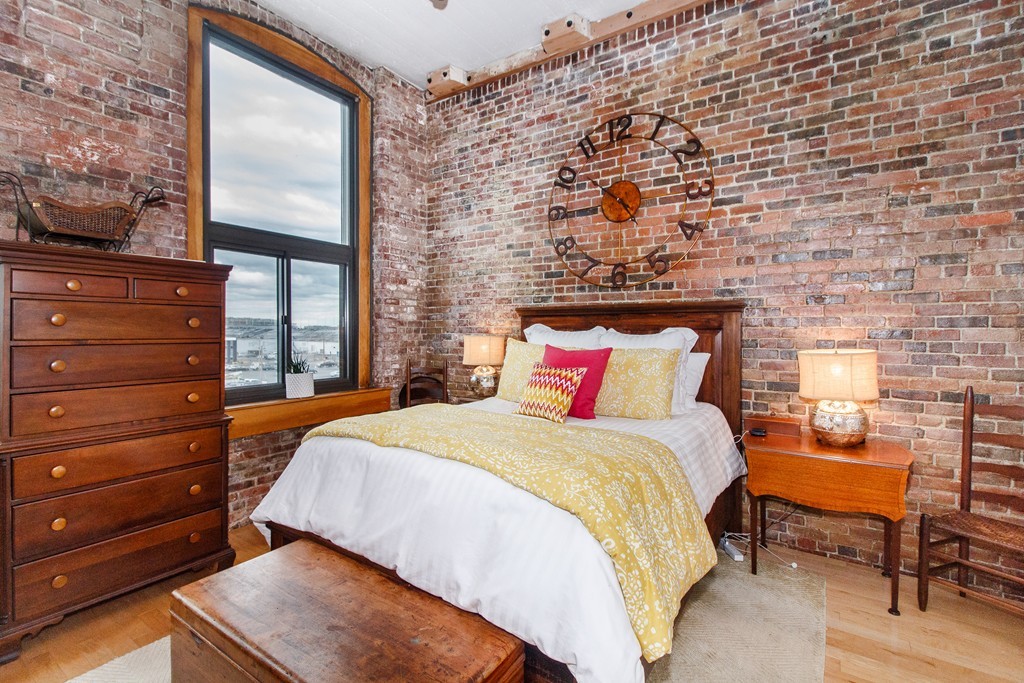320 West 2nd Street, Unit 412 Boston, MA 02127 - Photo 2 of 16 a bed room with a bed and a chair