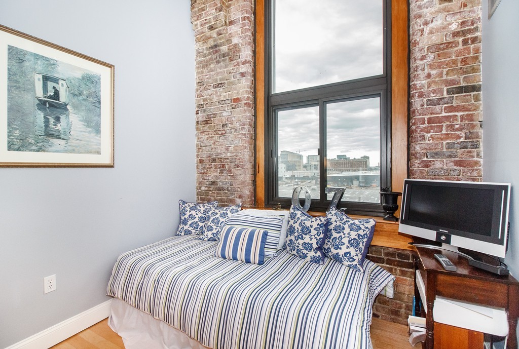 320 West 2nd Street, Unit 412 Boston, MA 02127 - Photo 5 of 16 a bedroom with a bed and a flat screen tv