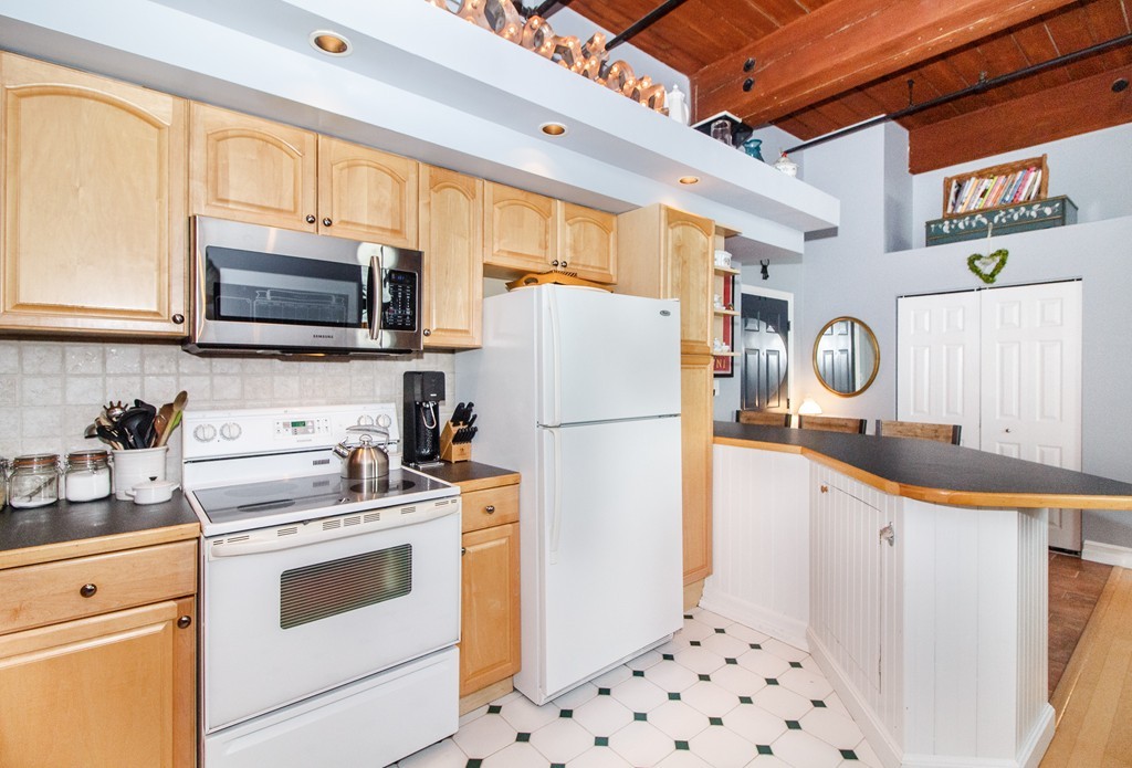 320 West 2nd Street, Unit 412 Boston, MA 02127 - Photo 8 of 16 a kitchen with granite countertop a white stove and refrigerator