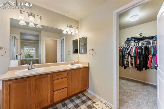 a bathroom with a sink double vanity and a mirror