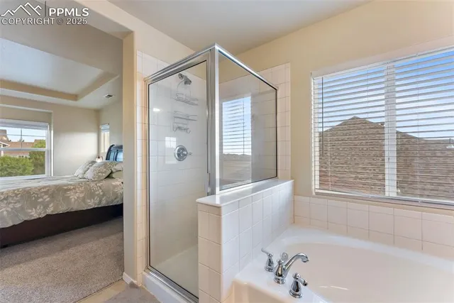 a en suite bathroom with a tub shower and window