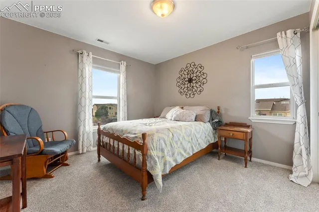 a spacious bedroom with a bed and a window