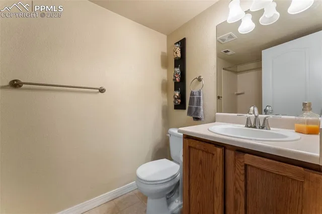 a bathroom with a granite countertop sink toilet and a mirror