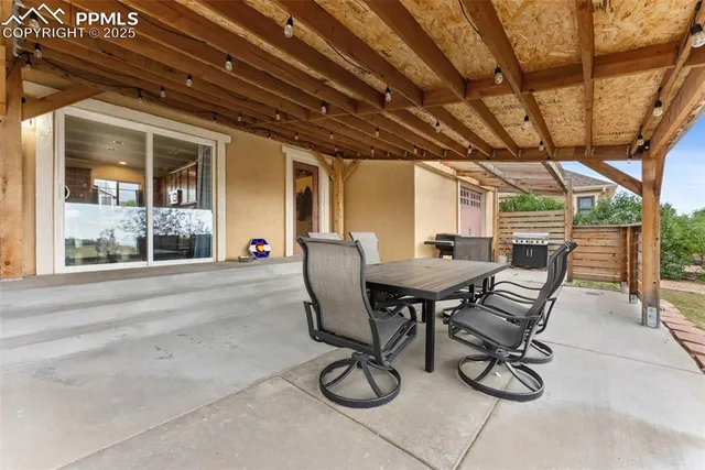a view of a patio with table and chairs