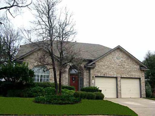 a front view of house with green space