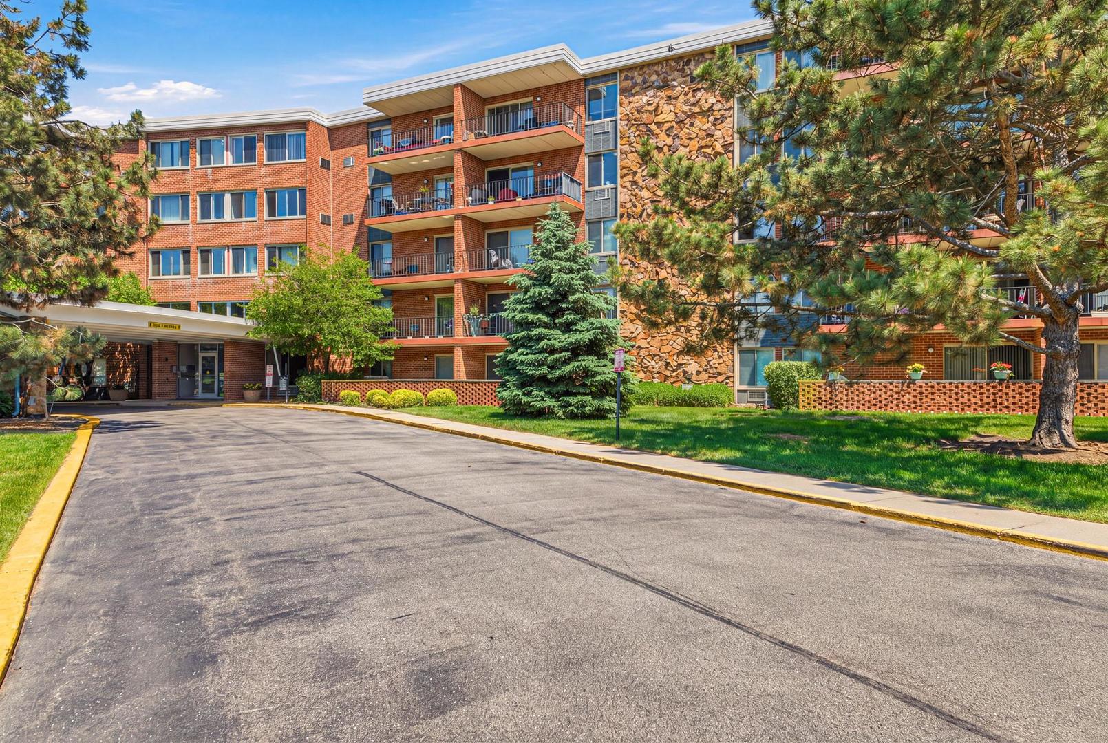 16 East Old Willow Road, Unit 332S Prospect Heights, IL 60070 - Photo 1 of 1 a front view of a building with a garden