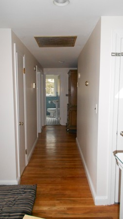 19 Leonard Road Sharon, MA 02067 - Photo 7 of 10 a view of a hallway with wooden floor and staircase