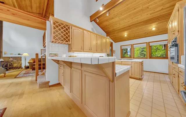 a kitchen with stainless steel appliances kitchen island granite countertop a sink and cabinets