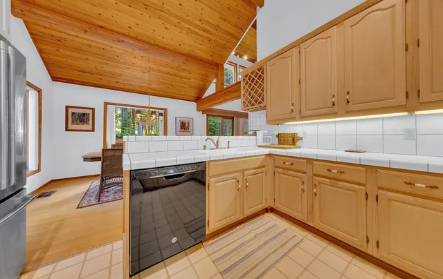 a kitchen with granite countertop a sink and cabinets