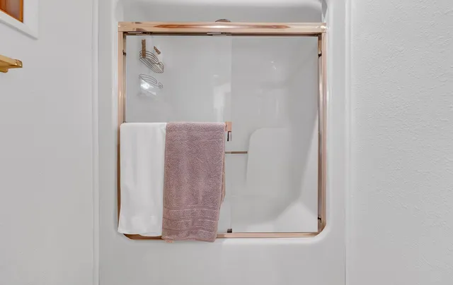 a bathroom with a glass shower door