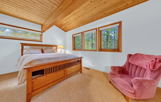 a bedroom with furniture and a large window