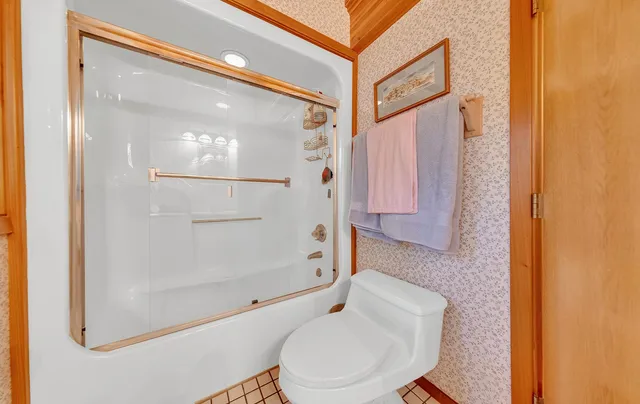 a bathroom with a toilet and a shower