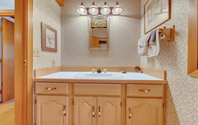 a bathroom with a sink and a mirror