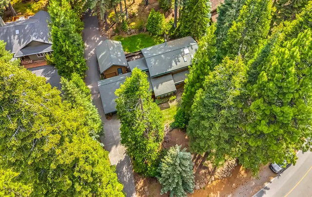 an aerial view of a house with swimming pool and garden space