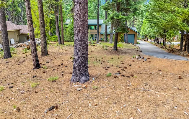 a front view of a house with a yard covered in snow