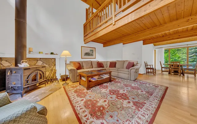 a living room with furniture a fireplace and next to a window
