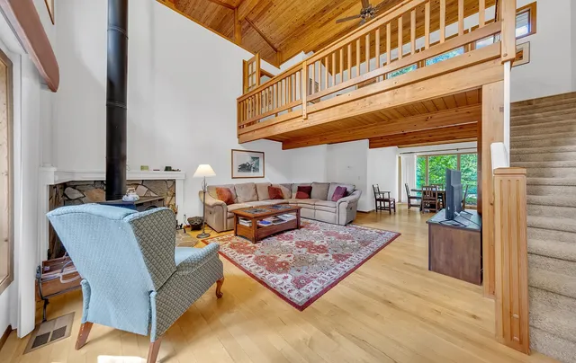 a living room with furniture a rug and a window