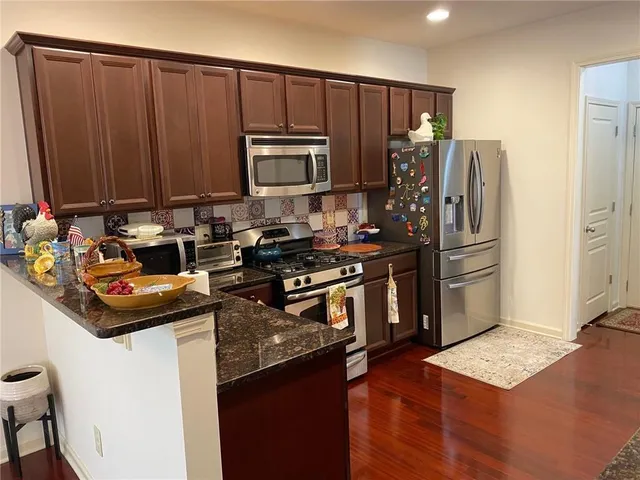 an aerial view of a city with lots of residential buildings and mountain view in back