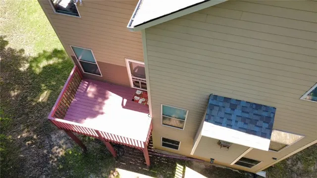 a view of a lush green forest with trees and houses